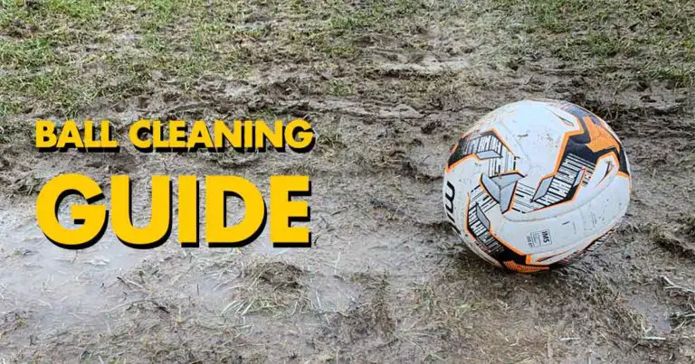 Dirty soccer ball sitting on a muddy playing field