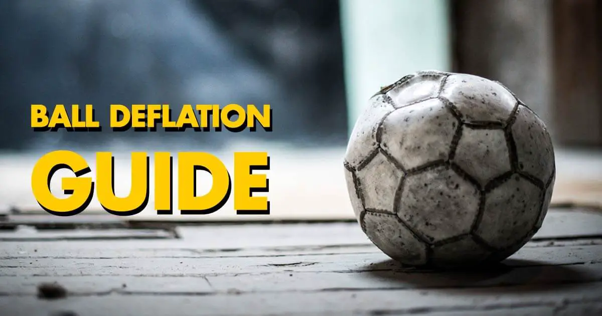 A deflated soccer ball sitting on a wooden floor